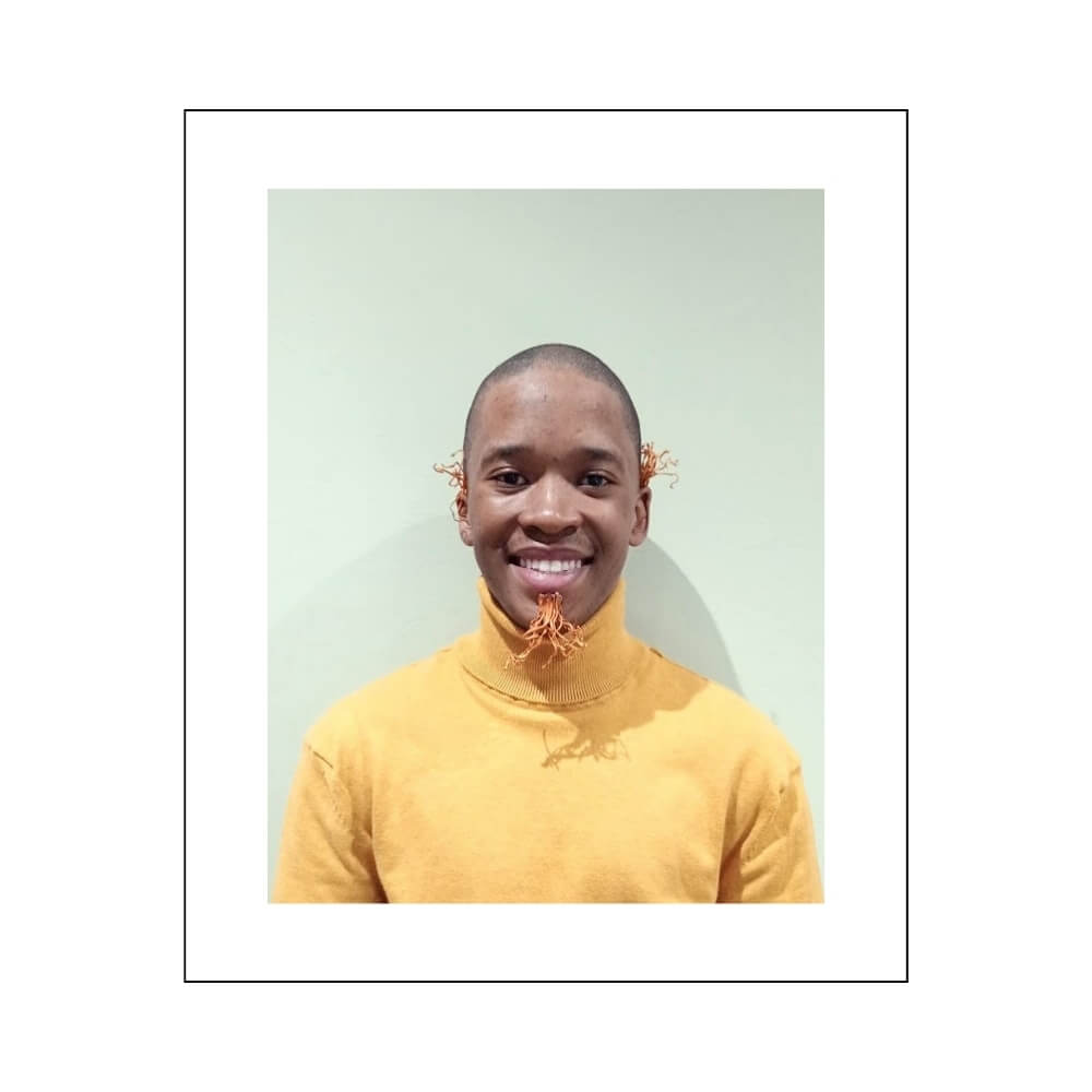 Theo, our playful customer support agent, smiling brightly with Cordyceps mushrooms whimsically attached to his ears and chin, reflecting his fun and engaging nature.